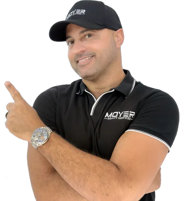 James Moyer Tucson Realtor pointing with smile in branded shirt and hat